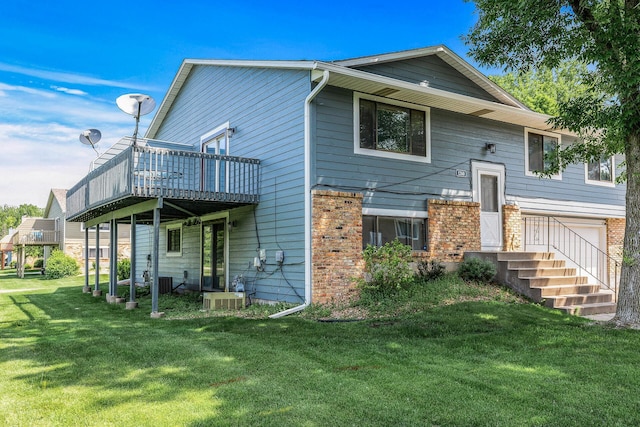 1260 Ferndale St N, Maplewood, MN 55119 - rear view of house with a lawn, a wooden deck, brick siding, and a garage