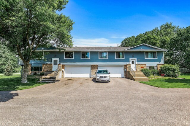 1260 Ferndale St N, Maplewood, MN 55119 - bi-level home with a garage, asphalt driveway, a front yard, and stairs