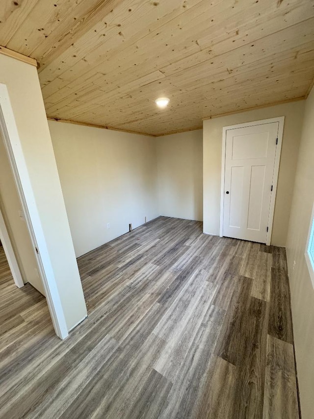 empty room featuring wood ceiling and wood finished floors