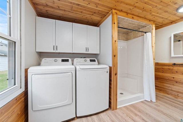 laundry room featuring washing machine and dryer, wooden ceiling, light wood-style floors, and laundry area