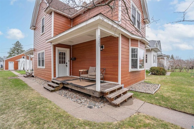 view of exterior entry featuring a yard