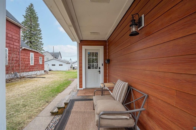 view of exterior entry featuring a lawn