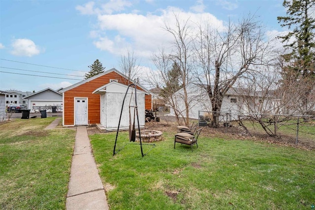 view of yard with an outbuilding, fence, and a shed