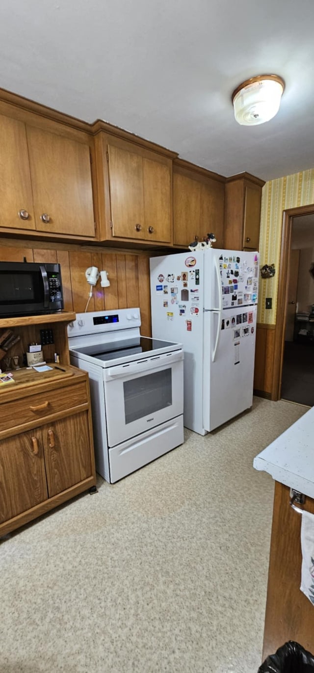 kitchen featuring white appliances and brown cabinets