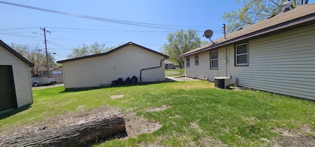 view of grassy yard with central air condition unit