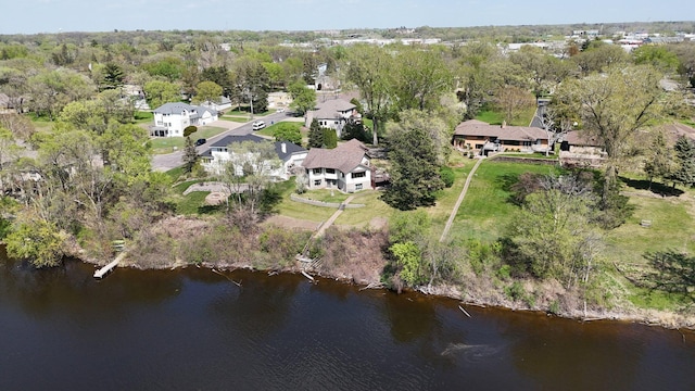 aerial view of property and surrounding area with a nearby body of water and a tree filled landscape