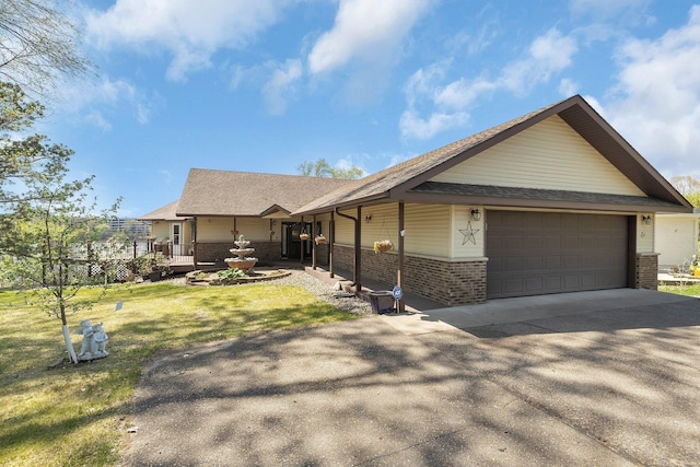 22 13th St S, Sauk Rapids, MN 56379 - ranch-style home with brick siding, an attached garage, concrete driveway, roof with shingles, and a front lawn
