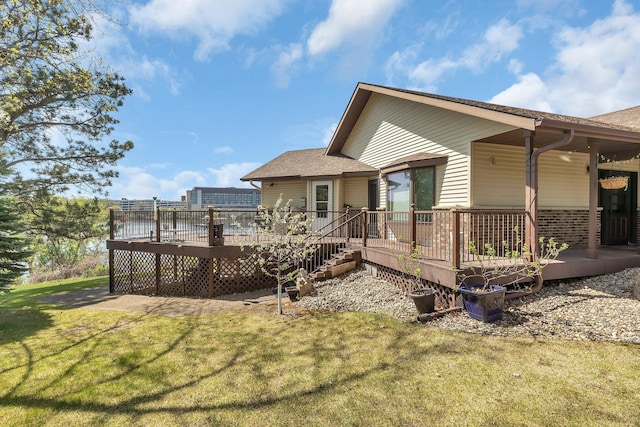 22 13th St S, Sauk Rapids, MN 56379 - rear view of house with a yard, a shingled roof, and a wooden deck