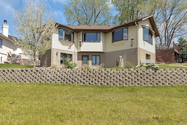 22 13th St S, Sauk Rapids, MN 56379 - rear view of property featuring a yard