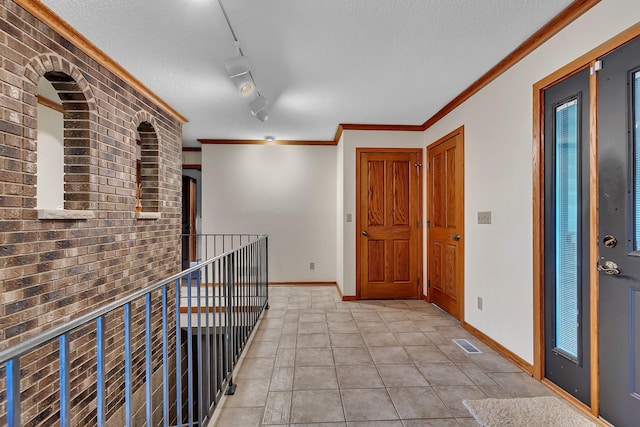 22 13th St S, Sauk Rapids, MN 56379 - hallway featuring baseboards, a textured ceiling, an upstairs landing, crown molding, and brick wall