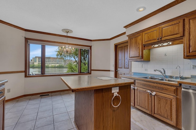 22 13th St S, Sauk Rapids, MN 56379 - kitchen featuring brown cabinets, decorative backsplash, a sink, dishwasher, and a center island