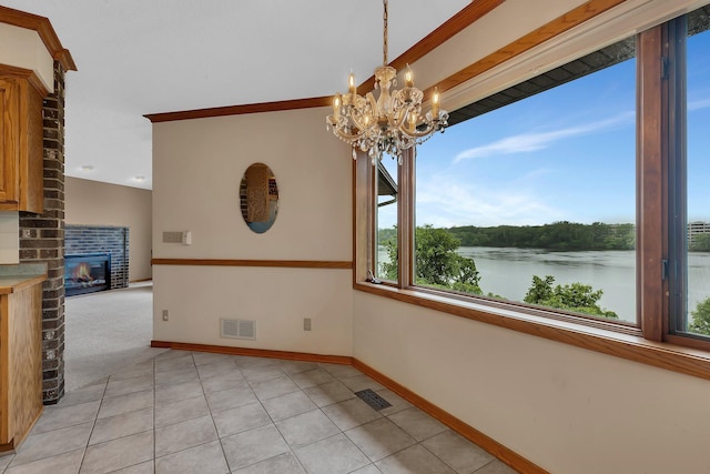 22 13th St S, Sauk Rapids, MN 56379 - unfurnished dining area featuring a chandelier, a water view, baseboards, light tile patterned floors, and a fireplace