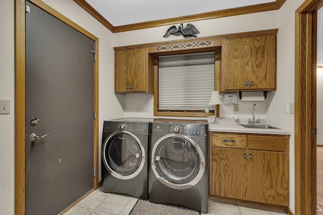 22 13th St S, Sauk Rapids, MN 56379 - washroom featuring cabinet space, light tile patterned floors, washing machine and clothes dryer, ornamental molding, and a textured ceiling