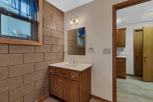 22 13th St S, Sauk Rapids, MN 56379 - bathroom featuring vanity, wood finished floors, and baseboards