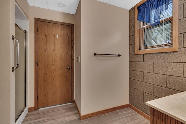 22 13th St S, Sauk Rapids, MN 56379 - full bathroom with wood finished floors, a shower with shower door, and baseboards