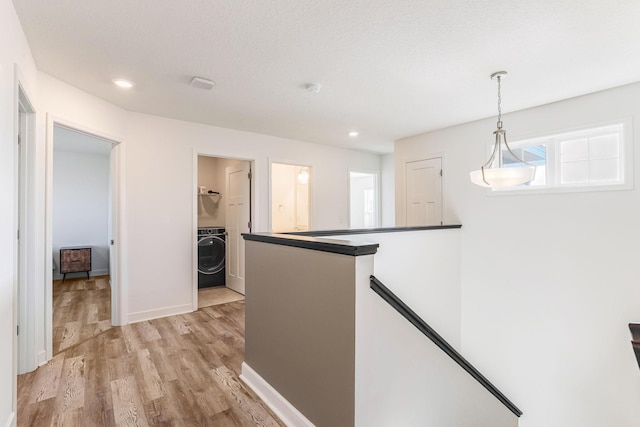 7145 208th Cv N, Forest Lake, MN 55025 - hall with washer / clothes dryer, recessed lighting, baseboards, light wood-style floors, and an upstairs landing