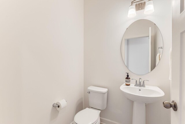 7145 208th Cv N, Forest Lake, MN 55025 - half bathroom featuring toilet, baseboards, and a sink