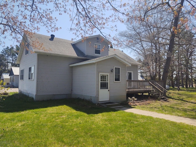 36998 Quest Rd, Hillman, MN 56338 - back of property with a wooden deck, a lawn, and roof with shingles