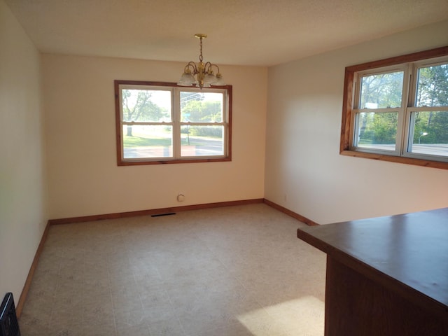 36998 Quest Rd, Hillman, MN 56338 - unfurnished dining area featuring a chandelier and baseboards