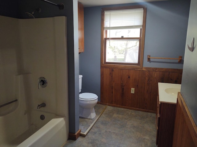 36998 Quest Rd, Hillman, MN 56338 - bathroom featuring toilet, vanity, wood walls, wainscoting, and shower / bathtub combination