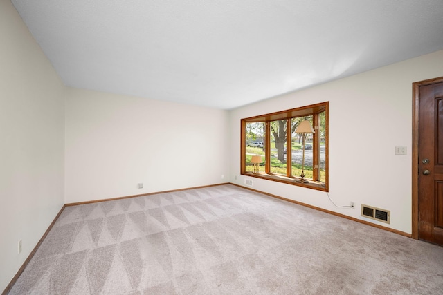 unfurnished room featuring light carpet, baseboards, and visible vents