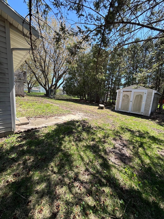 409 4th St NE, Hayfield, MN 55940 - view of grassy yard featuring a storage unit and an outdoor structure