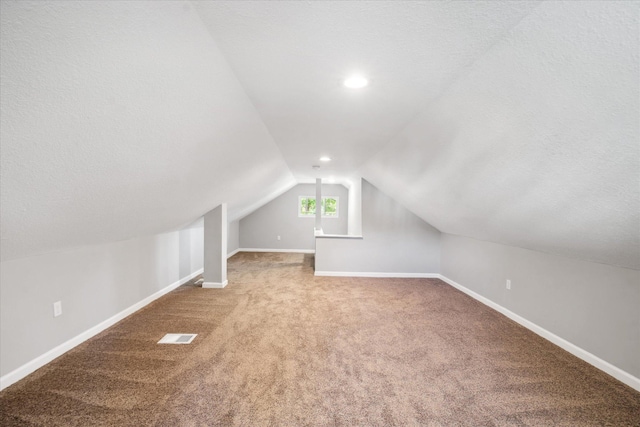 3410 Russell Ave N, Minneapolis, MN 55412 - additional living space featuring vaulted ceiling, carpet, baseboards, and a textured ceiling