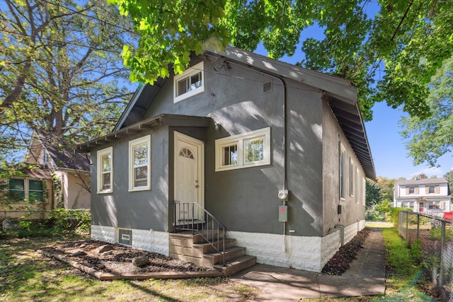 3410 Russell Ave N, Minneapolis, MN 55412 - view of front of home with fence and stucco siding