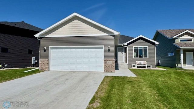 5477 11th St W, West Fargo, ND 58078 - view of front of property featuring concrete driveway, an attached garage, a front lawn, and brick siding