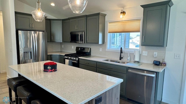 5477 11th St W, West Fargo, ND 58078 - kitchen with a center island, light stone counters, a sink, tasteful backsplash, and appliances with stainless steel finishes
