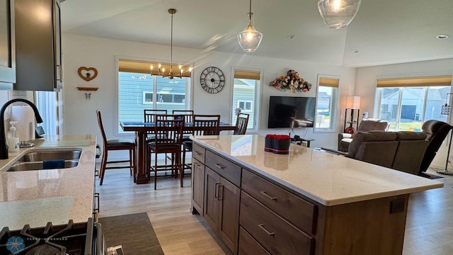 5477 11th St W, West Fargo, ND 58078 - kitchen featuring a wealth of natural light, light wood finished floors, pendant lighting, and a sink
