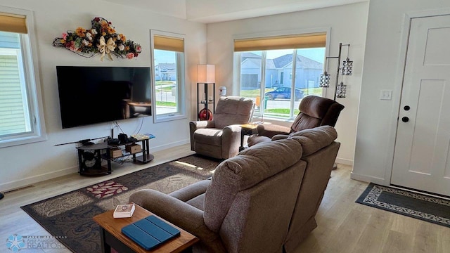 5477 11th St W, West Fargo, ND 58078 - living room featuring baseboards, visible vents, and wood finished floors