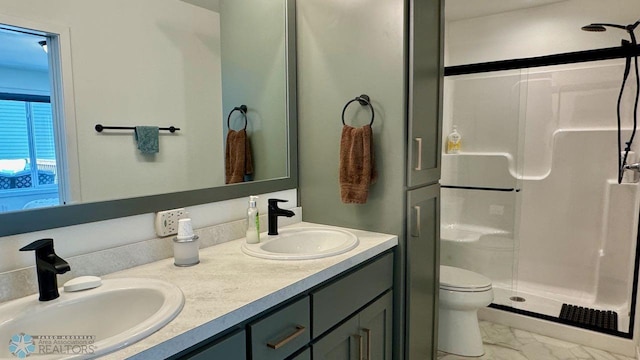 5477 11th St W, West Fargo, ND 58078 - bathroom with double vanity, toilet, a sink, a shower stall, and marble finish floor