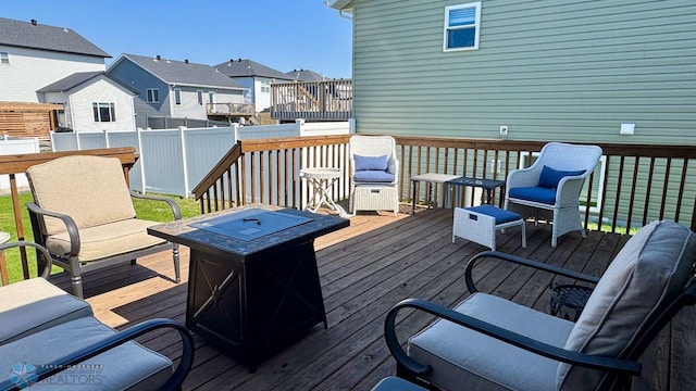 5477 11th St W, West Fargo, ND 58078 - wooden terrace with a residential view, a fire pit, and fence