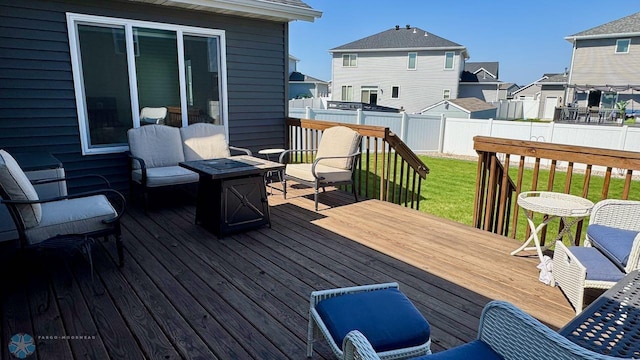 5477 11th St W, West Fargo, ND 58078 - wooden terrace with an outdoor fire pit, a residential view, a lawn, and a fenced backyard