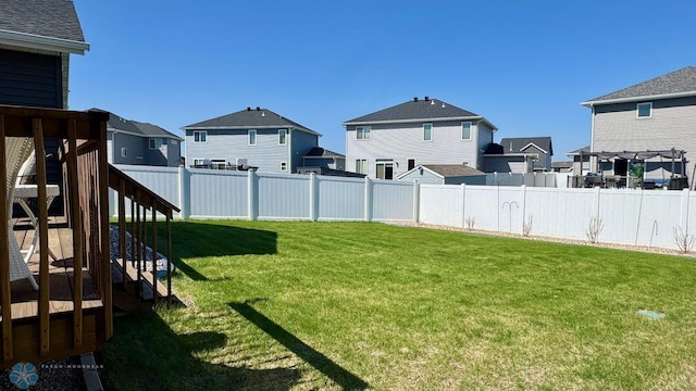 5477 11th St W, West Fargo, ND 58078 - view of yard with a residential view, a fenced backyard, and stairs
