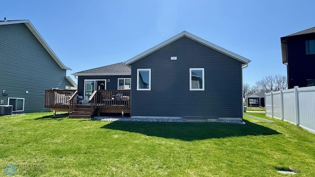 5477 11th St W, West Fargo, ND 58078 - rear view of house featuring a lawn, a deck, and cooling unit