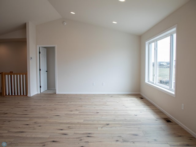 empty room featuring light wood-style flooring, visible vents, baseboards, vaulted ceiling, and recessed lighting