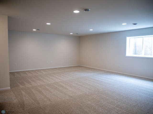 spare room featuring carpet flooring, baseboards, and recessed lighting