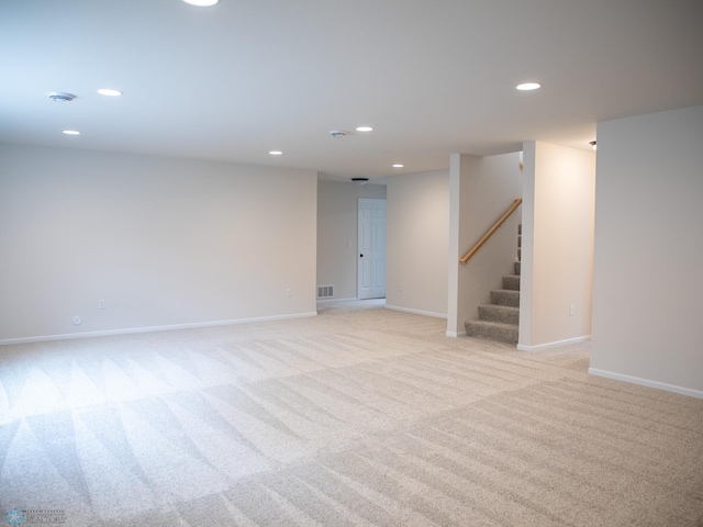 interior space with baseboards, stairs, recessed lighting, and light colored carpet