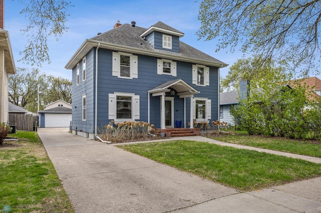 traditional style home featuring an outbuilding, a detached garage, and roof with shingles