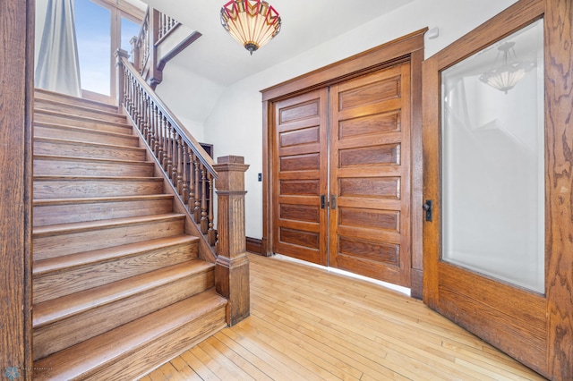 foyer featuring stairs and hardwood / wood-style flooring