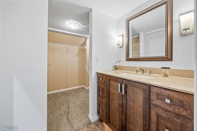 bathroom featuring vanity and a walk in closet