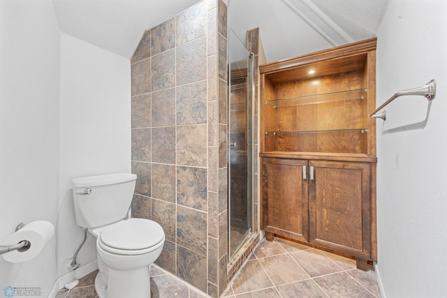 full bathroom featuring vaulted ceiling, a shower stall, toilet, baseboards, and tile patterned flooring