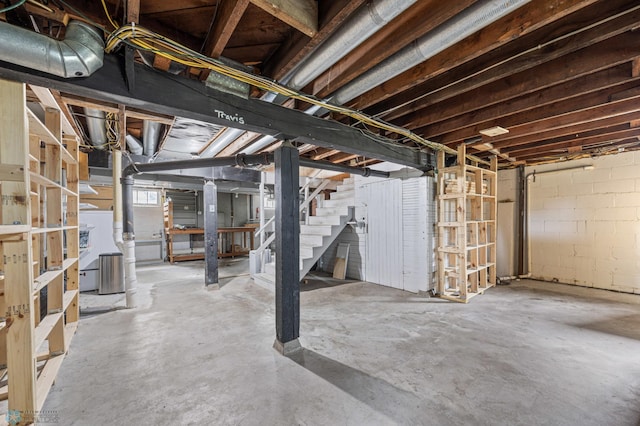 unfinished below grade area with stairway and concrete block wall