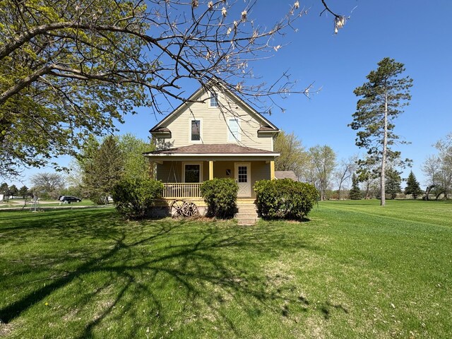 1105 13th St N, Benson, MN 56215 - view of side of property featuring covered porch and a yard