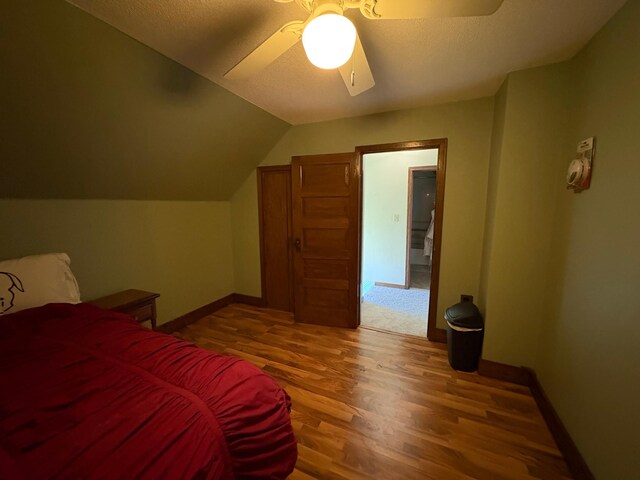 1105 13th St N, Benson, MN 56215 - bedroom with wood finished floors, ceiling fan, baseboards, and lofted ceiling