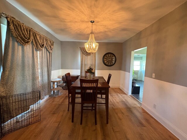 1105 13th St N, Benson, MN 56215 - dining room featuring a chandelier, wood finished floors, and baseboards