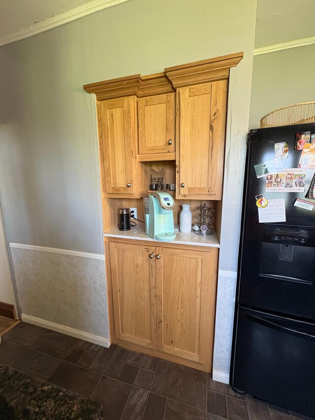1105 13th St N, Benson, MN 56215 - kitchen with black fridge, baseboards, light countertops, and crown molding