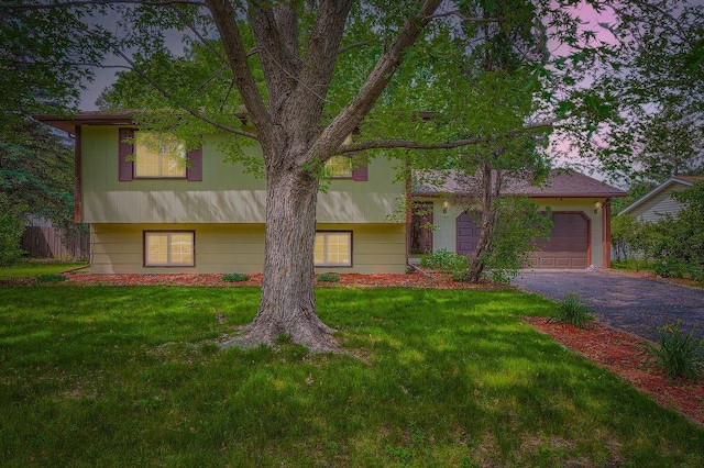 2108 Gunflint Trl, Brooklyn Park, MN 55444 - split level home with asphalt driveway, a garage, and a front lawn